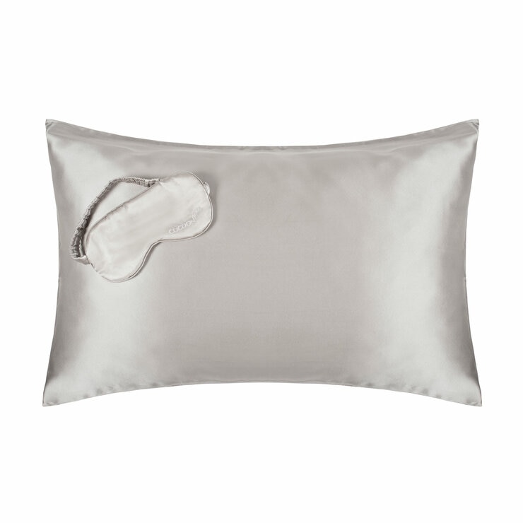 Platinum-coloured silk pillowcase with matching sleep mask embroidered with "COCOON". Smooth, glossy texture ideal for skin and hair health.